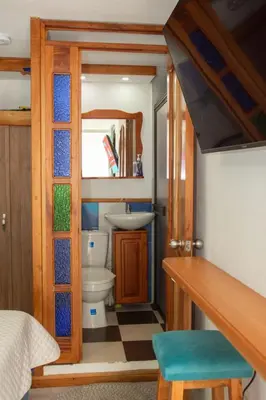 a small bathroom with a toilet and a sink at Habitación La Amelia in Jericó