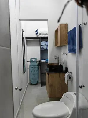 a bathroom with a white toilet and a sink at Apartaestudio completo en Itagüí - Shalom - 501 in Itagüí