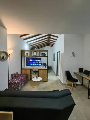 a living room with a couch and a tv at Apartaestudio completo en Itagüí - Shalom - 501 in Itagüí
