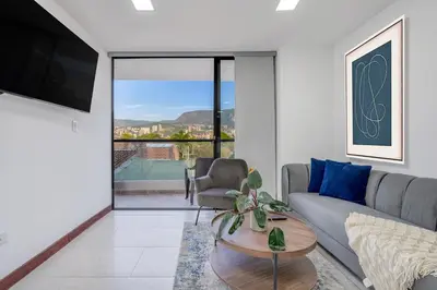 a living room with a couch and a table at Medellin-Cerca al Poblado-201 in Medellín