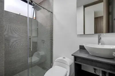 a bathroom with a glass shower and a sink at MEDELLIN- Cerca al Poblado - 301 in Medellín