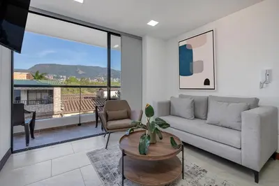 a living room with a couch and a table at MEDELLIN- Cerca al Poblado - 301 in Medellín