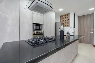 a kitchen with a counter with a stove top oven at MEDELLIN- Cerca al Poblado - 301 in Medellín