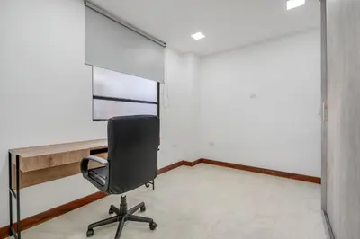 a chair in a room with a desk and a window at MEDELLIN- Cerca al Poblado-401 in Medellín