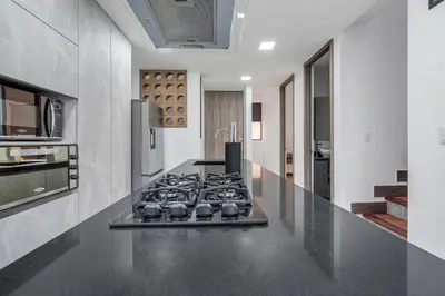 a kitchen with a stove and a counter top at MEDELLIN- Cerca al Poblado-401 in Medellín