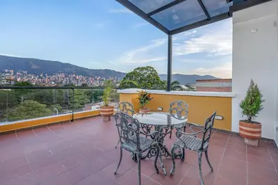a patio with a table and chairs on a balcony at MEDELLIN- Cerca al Poblado-401 in Medellín
