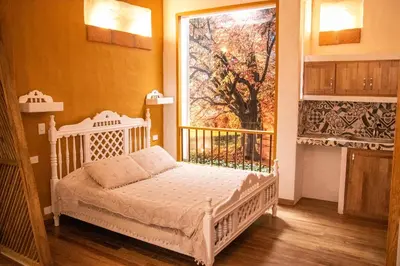 a bedroom with a crib and a large window at El Despertar Hotel in Jericó