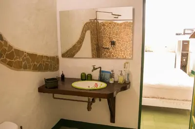 a bathroom with a sink and a mirror at El Despertar Hotel in Jericó