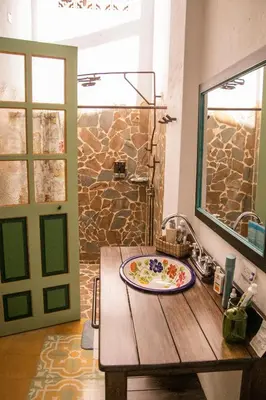 a wooden table with a plate on top of it at El Despertar Hotel in Jericó