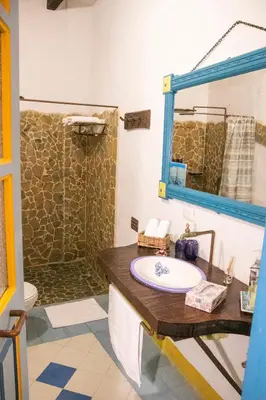 a bathroom with a sink and a shower at El Despertar Hotel in Jericó