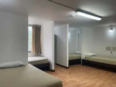 a room with two beds and a window at Hostal Lleras Calle 8 in Medellín