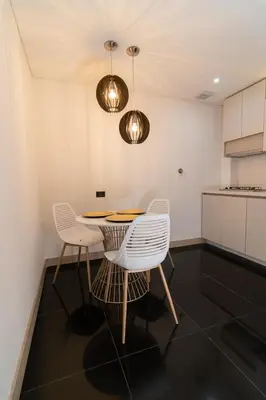 a dining room with a table and two chairs at Hotel Zona A in Medellín