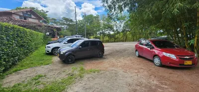 a group of cars parked on a dirt road at Hotel Parador del Gitano in Doradal