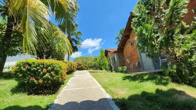 a house with palm trees and a sidewalk at Hotel Parador del Gitano in Doradal