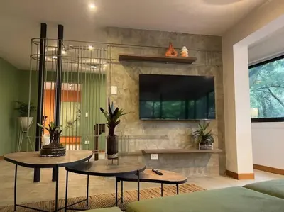 a living room with two tables and a flat screen tv at Apto BBC With Jacuzzi In Heart Of Provenza in Medellín