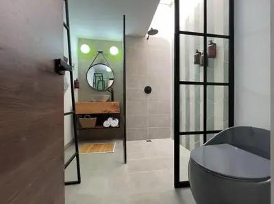 a bathroom with a toilet and a mirror at Apto BBC With Jacuzzi In Heart Of Provenza in Medellín