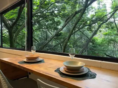 a table with two wine glasses and a window at Apto BBC With Jacuzzi In Heart Of Provenza in Medellín