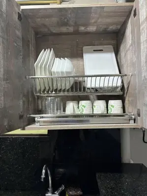 a shelf with a bunch of white dishes in a kitchen at Apartamento en Bello Medellín in Bello