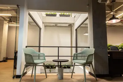 two chairs and a table in a room at Dormitorios en Medellín con áreas comunes, Coworking - Be Together by Roots Rentals TOG HAB in Medellín
