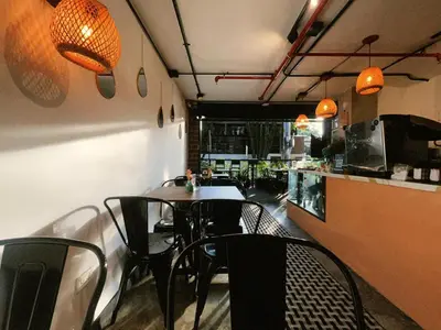 a dining room with a table and chairs in a restaurant at Dormitorios en Medellín con áreas comunes, Coworking - Be Together by Roots Rentals TOG HAB in Medellín
