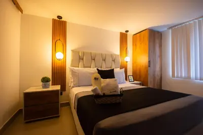a bedroom with a large bed and a window at Naiot Hotel Boutique in Medellín