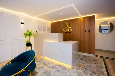 a lobby with a nault sign on the wall at Naiot Hotel Boutique in Medellín