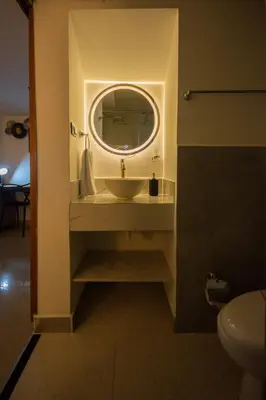 a bathroom with a sink and a mirror at Naiot Hotel Boutique in Medellín