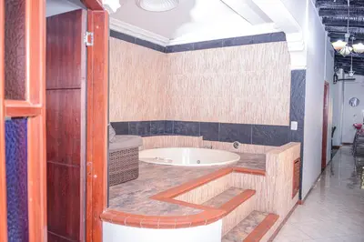 a bathroom with a bath tub in a room at Apartment El Jeffe Medellin in Medellín