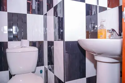 a bathroom with a toilet and a sink at Apartment El Jeffe Medellin in Medellín