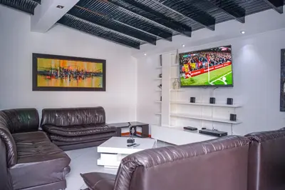 a living room with leather furniture and a flat screen tv at Apartment El Jeffe Medellin in Medellín