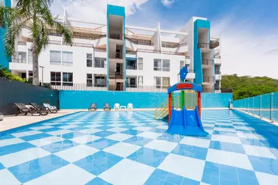 a pool with a playground in front of a building at Apartamento Vacacional San Jeronimo Paraíso Bali in San Jerónimo