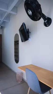 a room with a table and a speaker on the wall at Selva House in Medellín
