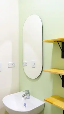 a bathroom with a sink and a mirror at Selva House in Medellín