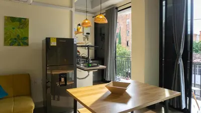 a kitchen with a wooden table and a refrigerator at Selva House in Medellín