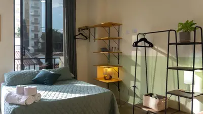 a bedroom with a bed and a window at Selva House in Medellín