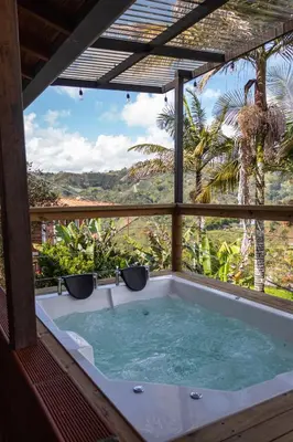 a jacuzzi tub in a house with a view at Mayka cabañas con JACUZZI in Guatapé