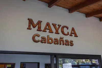 a sign for maya calabasas on a wall at Mayka cabañas con JACUZZI in Guatapé