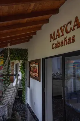 a restaurant with a sign on the side of a building at Mayka cabañas con JACUZZI in Guatapé