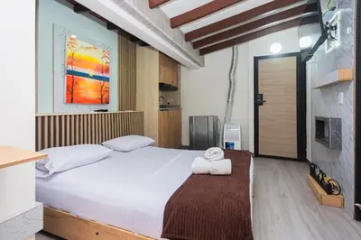 a bedroom with a bed with two towels on it at Hotel Lares 70 Laureles in Medellín