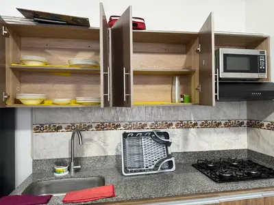 a kitchen counter with a sink and a microwave at Apartamento el Paraíso T3-302 in San Jerónimo