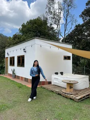a woman standing in front of a house at Nativo House in Guarne