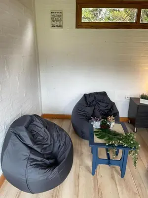 a room with two bean bag chairs and a table at Nativo House in Guarne