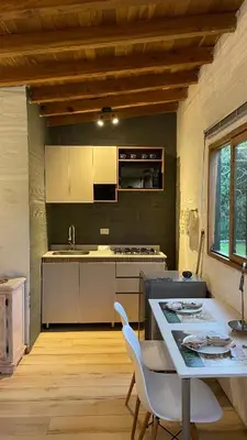 a kitchen with a table and a stove top oven at Nativo House in Guarne