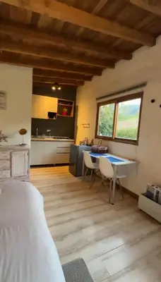 a living room with a table and a kitchen at Nativo House in Guarne