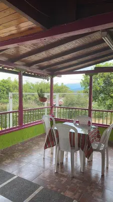 a table and chairs on a porch with a view at La victoria in Marsella