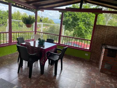 a table and chairs on a screened porch with a fireplace at La victoria in Marsella