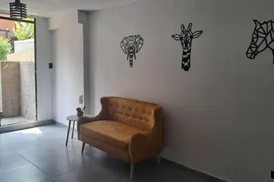 a living room with a couch and some decals on the wall at Exclusive Studio in the Best Laureles Area in Medellín