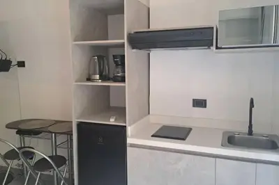 a small kitchen with a sink and a table at Exclusive Studio in the Best Laureles Area in Medellín