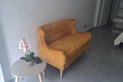 a living room with a brown chair and a table at Exclusive Studio in the Best Laureles Area in Medellín