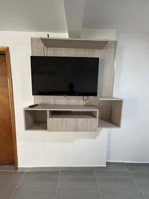 a tv on a wall in a room at Casa Vernazza in Manizales